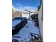 Backyard with a detached garage, car, and a small amount of snow covering the ground at 1130 Orchard St, Golden, CO 80401