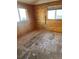 Unfurnished bedroom featuring light brown wood walls, tan floor and dual pane windows at 1130 Orchard St, Golden, CO 80401