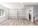 Finished basement with spacious shelving and laminate flooring at 16321 Clayton St, Thornton, CO 80602