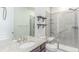 Modern bathroom featuring granite countertop, a glass-enclosed shower, and gray shelving at 16321 Clayton St, Thornton, CO 80602