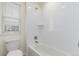 Bright bathroom with a white tiled shower/tub combination at 16321 Clayton St, Thornton, CO 80602