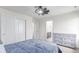 Bedroom with carpet, ceiling fan, and access to closet and bathroom at 16321 Clayton St, Thornton, CO 80602