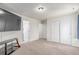 Bedroom area with neutral carpet, multiple doors, and media center at 16321 Clayton St, Thornton, CO 80602