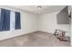 This bedroom features neutral carpet, a large window, and a mounted television at 16321 Clayton St, Thornton, CO 80602