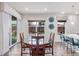 Cozy dining area with large windows, a stylish chandelier, and a modern table at 16321 Clayton St, Thornton, CO 80602
