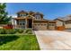 Charming two-story home with a welcoming front porch and a well-manicured lawn at 16321 Clayton St, Thornton, CO 80602