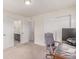 Home office area with neutral carpet, multiple doors, and office furniture at 16321 Clayton St, Thornton, CO 80602