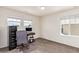 Home office space featuring large windows for natural light and neutral carpet at 16321 Clayton St, Thornton, CO 80602