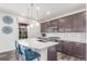 Modern kitchen featuring stainless steel appliances, a center island, and barstool seating at 16321 Clayton St, Thornton, CO 80602