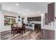 Open-concept kitchen and dining area with modern finishes and ample natural light at 16321 Clayton St, Thornton, CO 80602