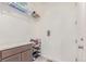 Well-organized laundry room with shelving, storage, and bright countertops at 16321 Clayton St, Thornton, CO 80602
