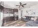 Cozy living room features a wet bar, stainless steel refrigerator, and comfortable seating at 16321 Clayton St, Thornton, CO 80602