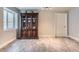 Finished basement with luxury vinyl plank flooring and a glass door cabinet at 7203 W Pacific Ave, Lakewood, CO 80227