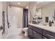 Bathroom with shower-tub combo and vanity with generous storage space at 7203 W Pacific Ave, Lakewood, CO 80227