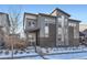 Modern gray two story home with brick accents, landscaping and a welcoming front porch at 7203 W Pacific Ave, Lakewood, CO 80227