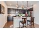 Well-equipped kitchen with dark wood cabinets, a kitchen island, and stainless steel appliances at 7203 W Pacific Ave, Lakewood, CO 80227