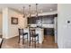Bright kitchen with a large island, dark cabinets, stainless appliances, and pendant lighting at 7203 W Pacific Ave, Lakewood, CO 80227