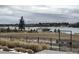 Beautiful lake view with trees, grass, and a pathway to enjoy the outdoors at 7203 W Pacific Ave, Lakewood, CO 80227