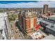 Stunning aerial view of building with a large patio, showcasing its location and surrounding cityscape at 1950 N Logan St # 411, Denver, CO 80203