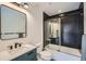 Modern bathroom features dark hexagon tile, glass shower door, and stylish vanity at 1950 N Logan St # 411, Denver, CO 80203