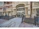 Elegant building entrance with stone columns, glass doors, and iron fencing, creating a welcoming atmosphere at 1950 N Logan St # 411, Denver, CO 80203