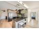 Contemporary kitchen with a gray island, pendant lighting, and stainless steel appliances, open to the living area at 1950 N Logan St # 411, Denver, CO 80203