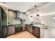 Modern kitchen featuring stainless steel appliances, sleek countertops, and stylish green tile backsplash at 1950 N Logan St # 411, Denver, CO 80203
