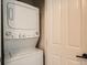 Efficient laundry closet with a stacked washer and dryer unit at 1950 N Logan St # 411, Denver, CO 80203