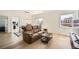 Bright living room with hardwood floors, modern lighting, and access to outdoor balcony at 1950 N Logan St # 411, Denver, CO 80203
