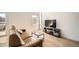 Comfortable living area with a plush leather couch and large screen TV at 1950 N Logan St # 411, Denver, CO 80203