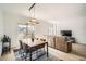 Open-concept living and dining area with hardwood floors, stylish furnishings, and access to balcony at 1950 N Logan St # 411, Denver, CO 80203