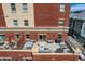 Expansive brick patio featuring an outdoor dining area and comfortable seating with views of the city at 1950 N Logan St # 411, Denver, CO 80203