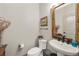 Stylish powder room featuring modern fixtures, a vanity sink, and decorative accents at 8872 E 47Th Ave, Denver, CO 80238