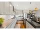 Modern kitchen boasts granite countertops, stainless steel appliances, and ample cabinet space at 8872 E 47Th Ave, Denver, CO 80238
