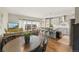 Open living space with kitchen, dining area, and view from sliding glass door at 8872 E 47Th Ave, Denver, CO 80238