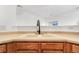 Kitchen sink with bronze faucet and cream cabinets, offering a clean and functional space at 9032 Gale Blvd # 1, Thornton, CO 80260