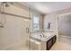 Elegant bathroom featuring a glass-enclosed shower and a soaking tub with stylish fixtures at 4545 S Monaco St # 436, Denver, CO 80237