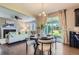 Open dining area connecting to the living room, featuring a table, chairs, and sliding glass doors to the yard at 4545 S Monaco St # 436, Denver, CO 80237