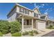 Charming two-story home featuring stone accents, a covered porch, and a two-car garage with driveway at 4545 S Monaco St # 436, Denver, CO 80237