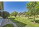 Well-maintained lawn with fresh grass, landscaping, and a fence against a clear blue sky at 4545 S Monaco St # 436, Denver, CO 80237