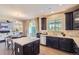 Bright kitchen features dark wood cabinets, stainless appliances, a center island, and access to the backyard at 4545 S Monaco St # 436, Denver, CO 80237