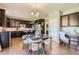 Open-concept kitchen with dark cabinetry, stainless appliances, adjoining dining area, and a built-in desk at 4545 S Monaco St # 436, Denver, CO 80237