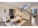 Bright living area with modern furnishings, a decorative rug, and staircase with contemporary design at 4545 S Monaco St # 436, Denver, CO 80237