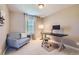 Cozy bedroom featuring a desk, modern chair, and ample natural light at 4545 S Monaco St, Denver, CO 80237