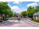 Gated entrance to the community with lush greenery and manicured landscaping at 4545 S Monaco St, Denver, CO 80237