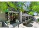 Charming outdoor patio with decorative plants and umbrellas, adjacent to a brick building with a welcoming entrance at 4545 S Monaco St, Denver, CO 80237
