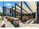 Inviting outdoor seating area with picnic tables and umbrellas, perfect for enjoying a meal or drinks outside at 4545 S Monaco St, Denver, CO 80237