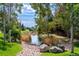 Scenic view of a pond with mature trees and rock landscaping at 4545 S Monaco St, Denver, CO 80237