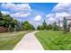 Scenic walking path surrounded by lush greenery and well-maintained lawns at 4545 S Monaco St, Denver, CO 80237