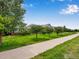 Walking path with lush green grass and trees in neighborhood at 4545 S Monaco St, Denver, CO 80237